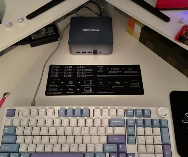 External appearance of the Geekom AX8 Max mini PC next to a keyboard